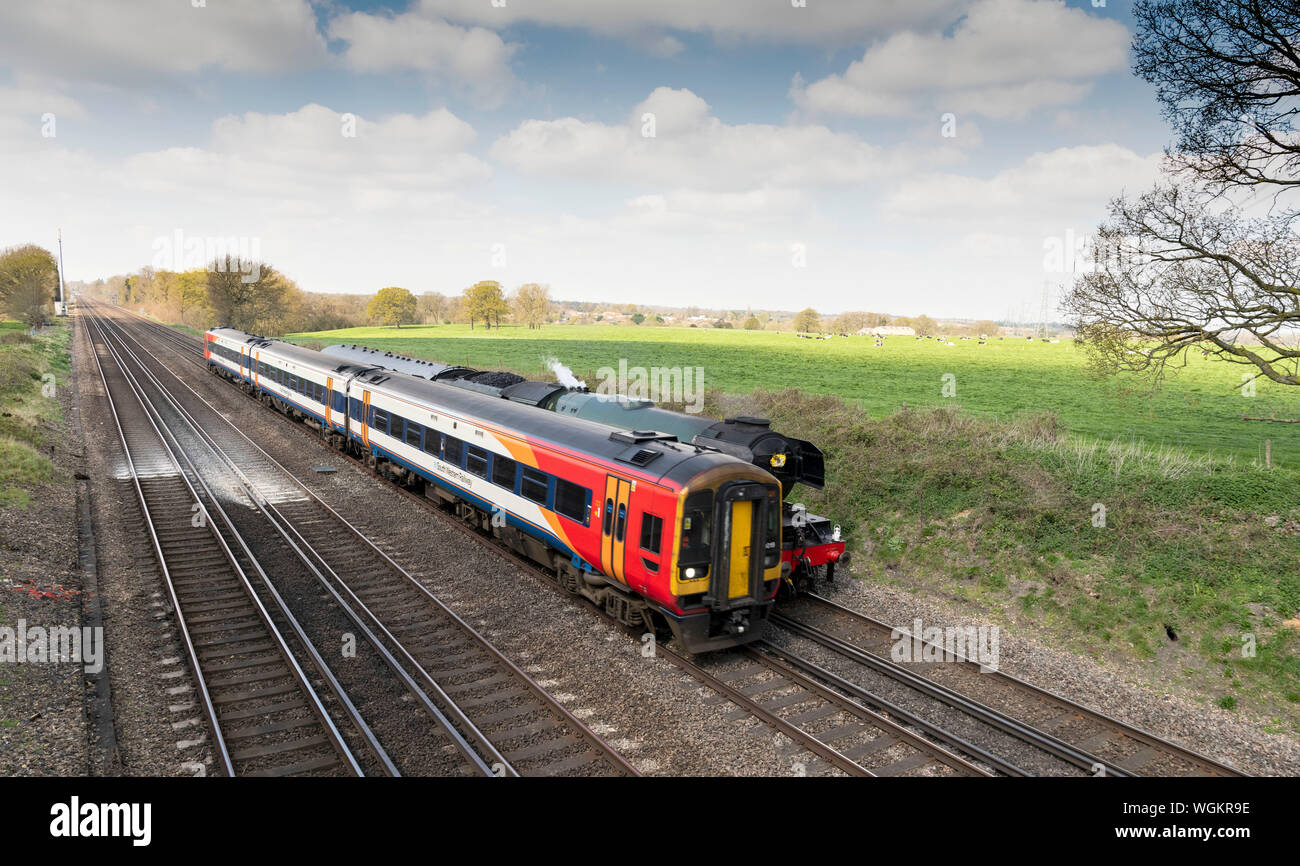 The Flying Scotsman overtaken by South Western train Stock Photo