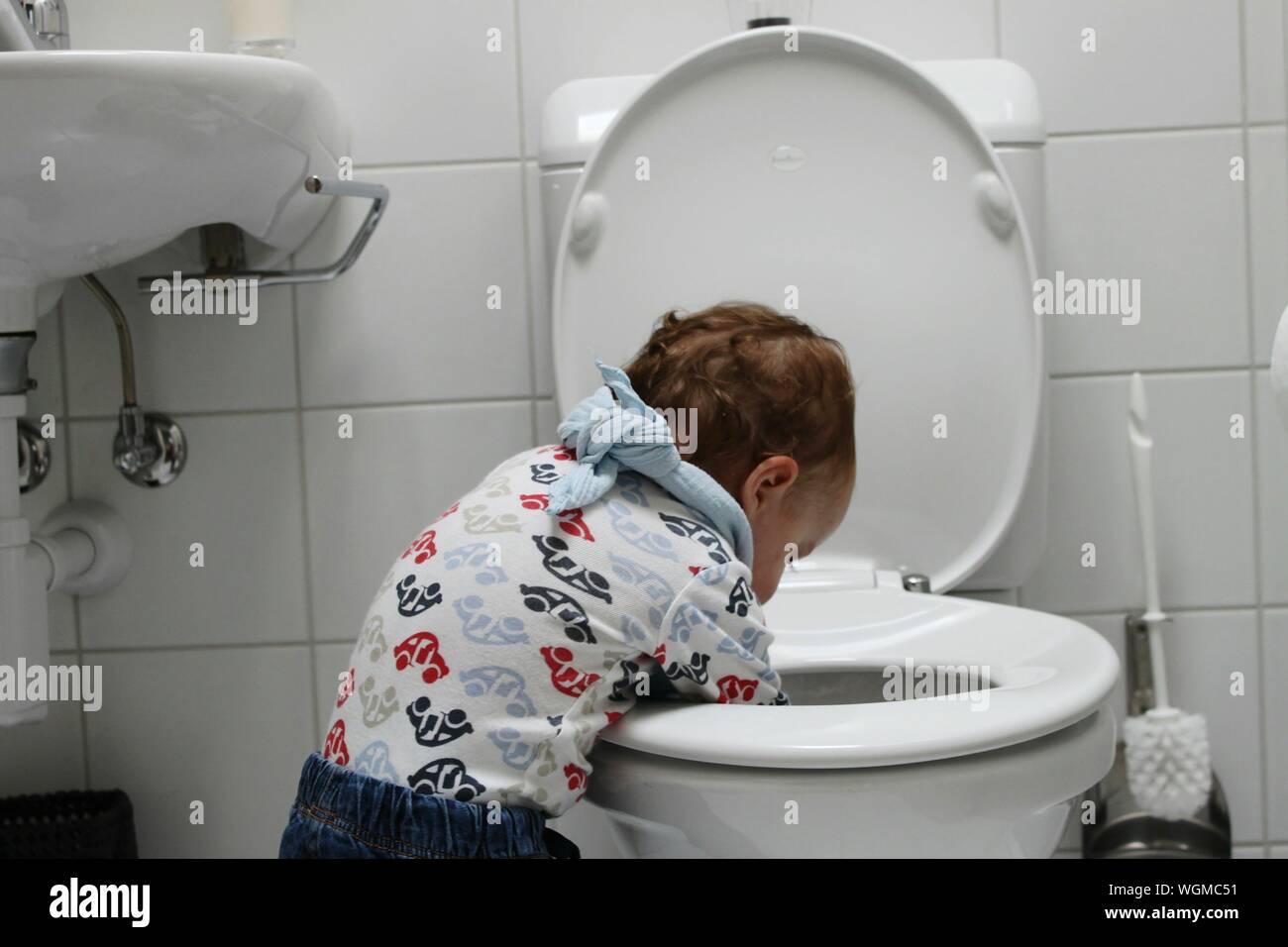 Boy child flushing toilet hires stock photography and images Alamy
