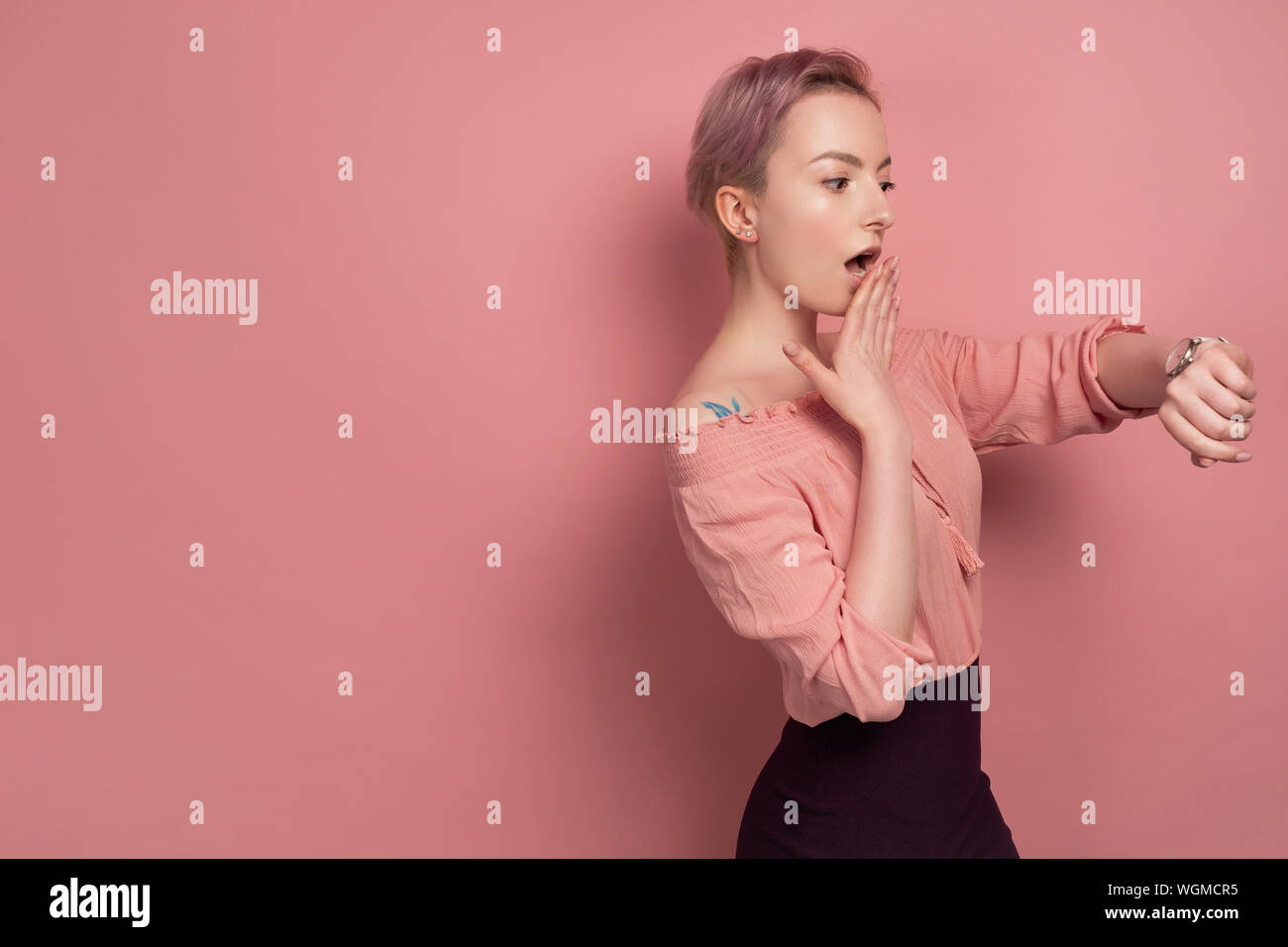 A Girl With Short Hair In A Blouse With Bare Shoulders Looks At