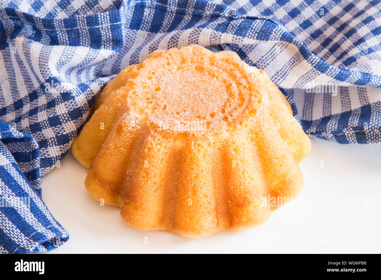 Mini bundt cake with a blue cloth on white background Stock Photo