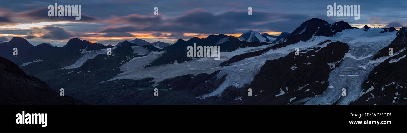 Panorama of sunrise above glacier in European Alps Stock Photo