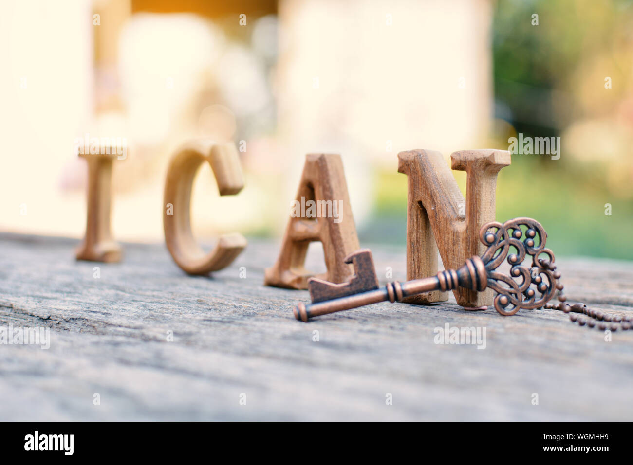 Surface Level View Of Wooden Text And Antique Metallic Key On Table Stock Photo