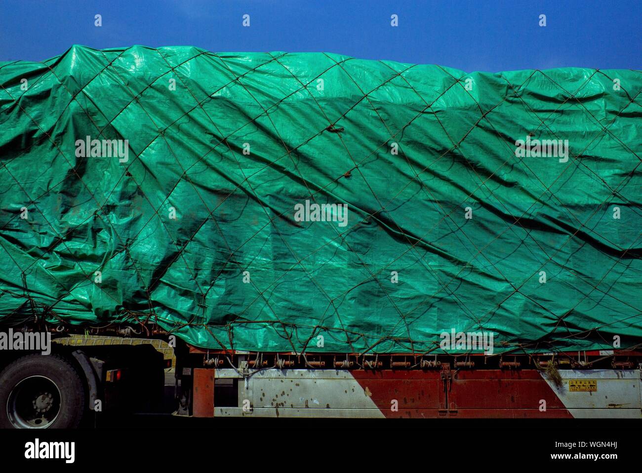 Cropped Image Of Truck Covered With Tarpaulin Stock Photo Alamy
