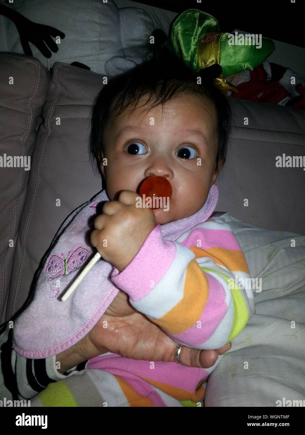 Cute Baby Girl Licking Lollipop At Home Stock Photo Alamy