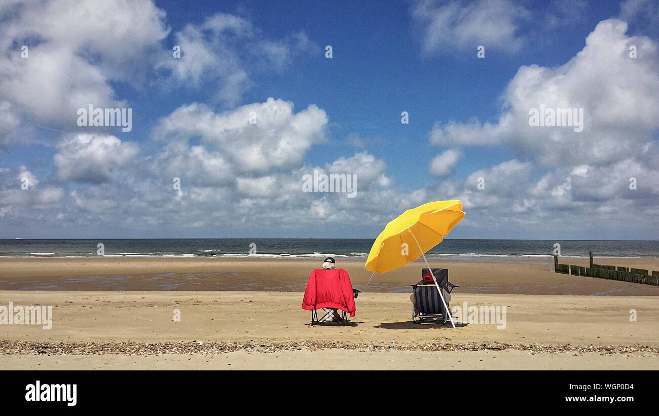Person sitting in beach chair hires stock photography and images Alamy
