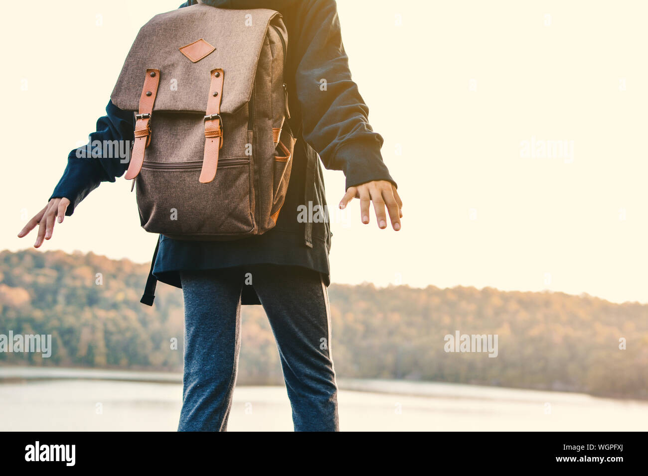 Midsection Of Person Standing By Lake Stock Photo