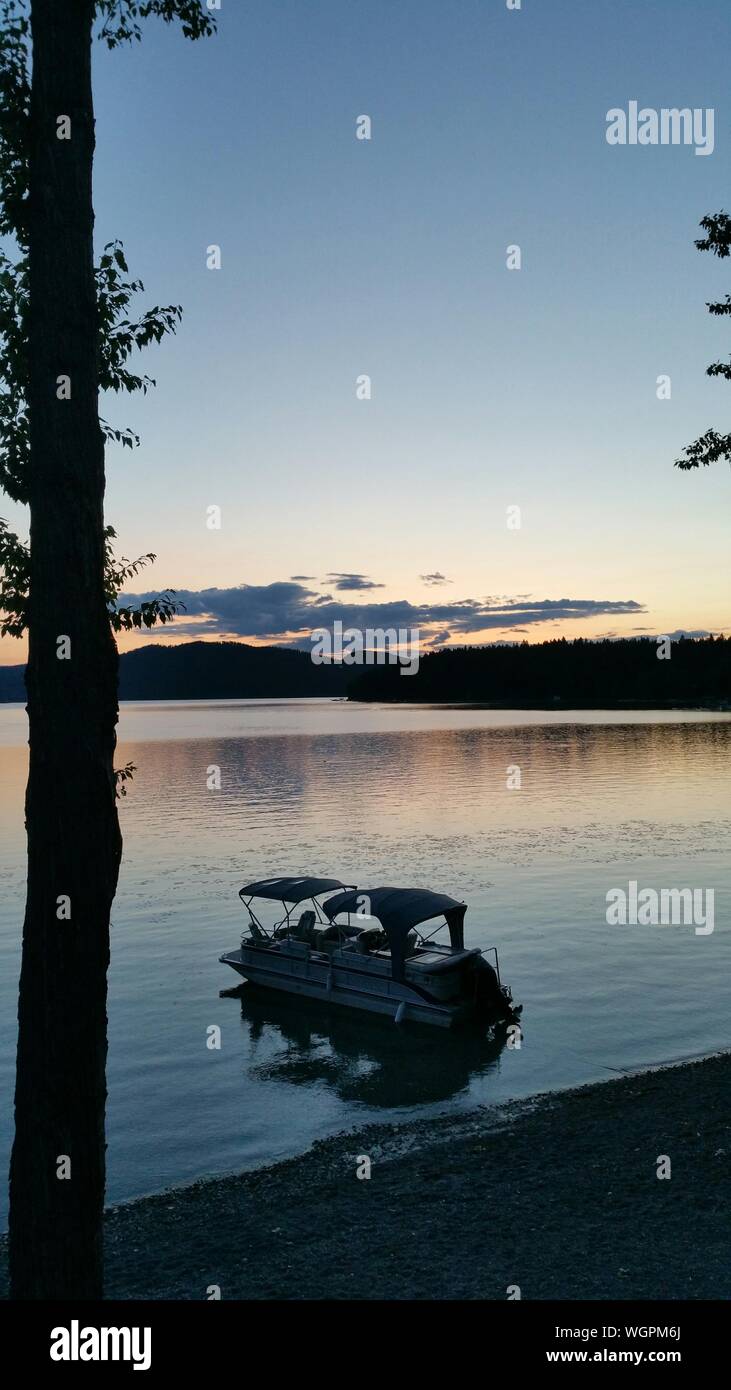 Recreational Boat In Lake At Dusk Stock Photo