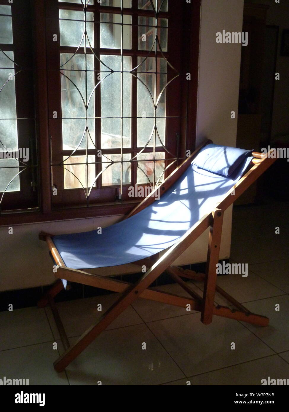Foldable Chair By Window At Home Stock Photo