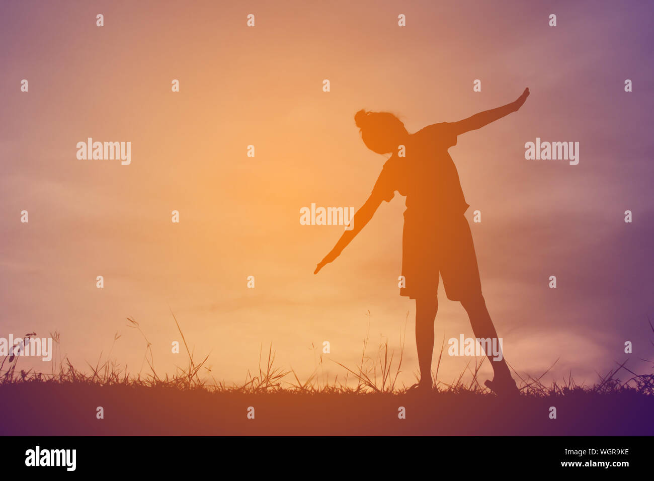 Silhouette girl standing outstretched arms hi-res stock photography and ...