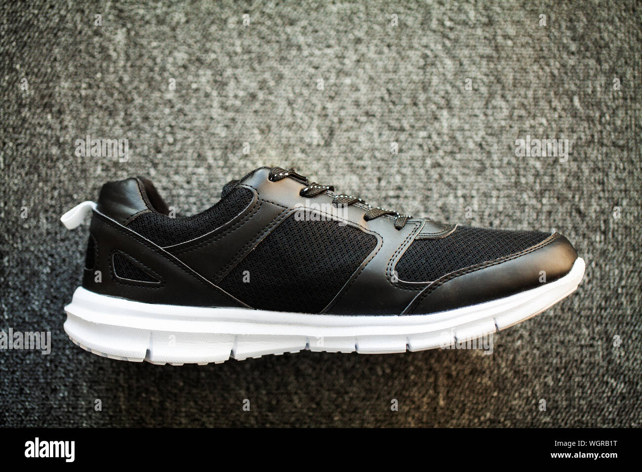 Pair of new stylish sneakers on floor at home Stock Photo - Alamy