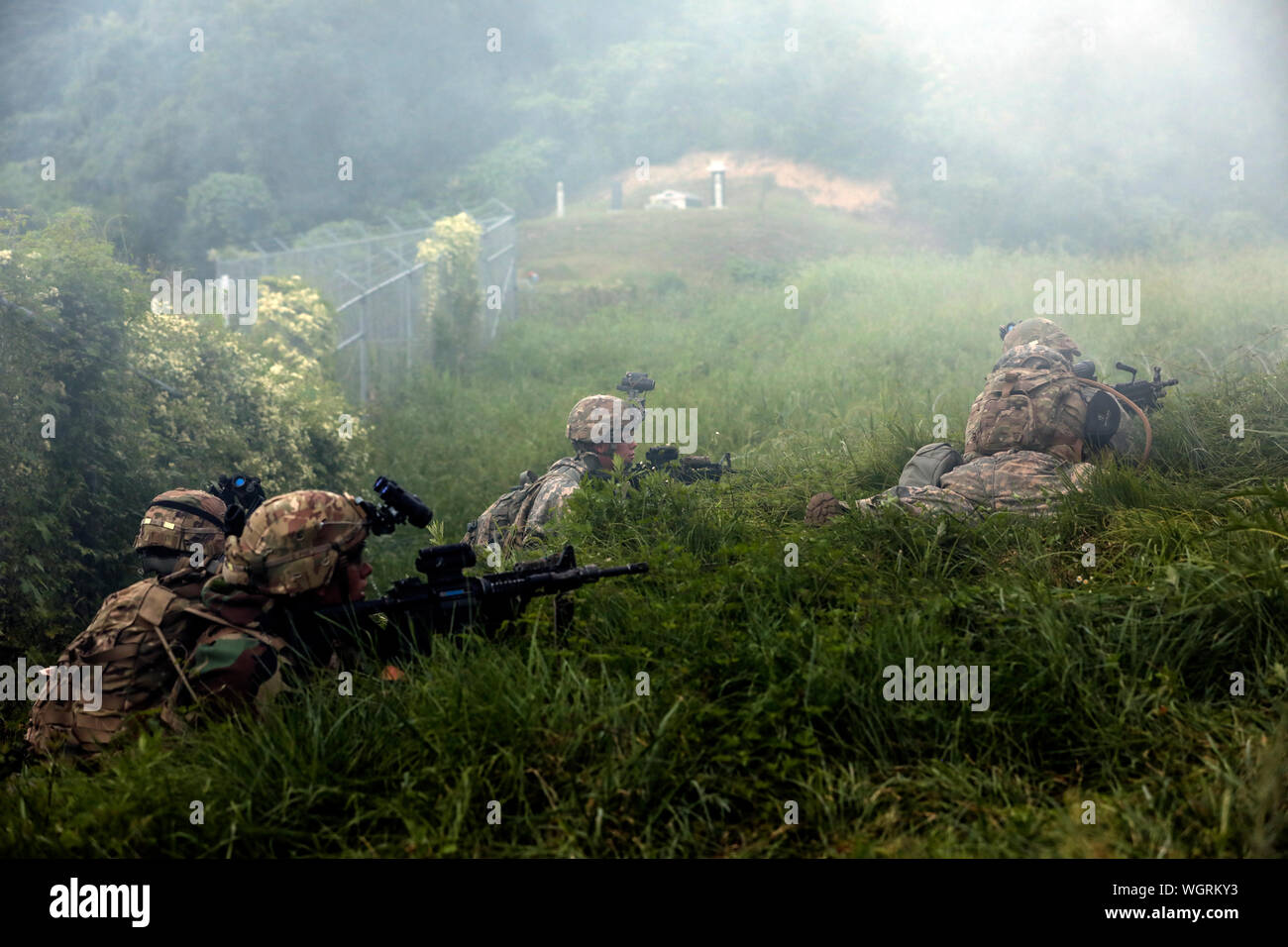 Soldiers with A Co., 2nd Battalion, 7th Cavalry Regiment, 3rd Armored Brigade Combat Team, 1st Cavalry Division prepare to assault an objective during platoon situational training exercises on August, 28. The Greywolf Brigade is on a nine-month rotation to the Republic of Korea in support of ROK allies and common defense of the peninsula. Stock Photo
