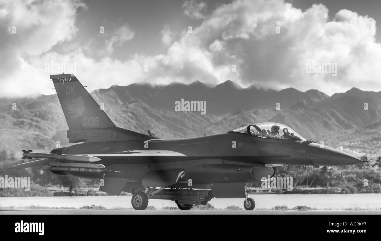 An F-16 Tulsa Viper taxies for flight during a Sentry Aloha exercise Aug. 29, 2019, at Joint Base Pearl Harbor-Hickam, Hawaii. The Hawaii Air National Guard exercise is held several times a year to provide aircraft with dissimilar combat training among participating flying and support units. (U.S. Air National Guard photo by Master Sgt. C.T. Michael) Stock Photo