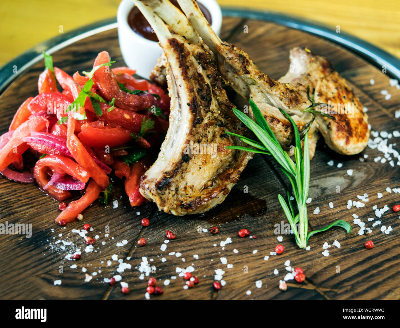 Close-up Of Lamb Chop With Rosemary On Cutting Board Stock Photo