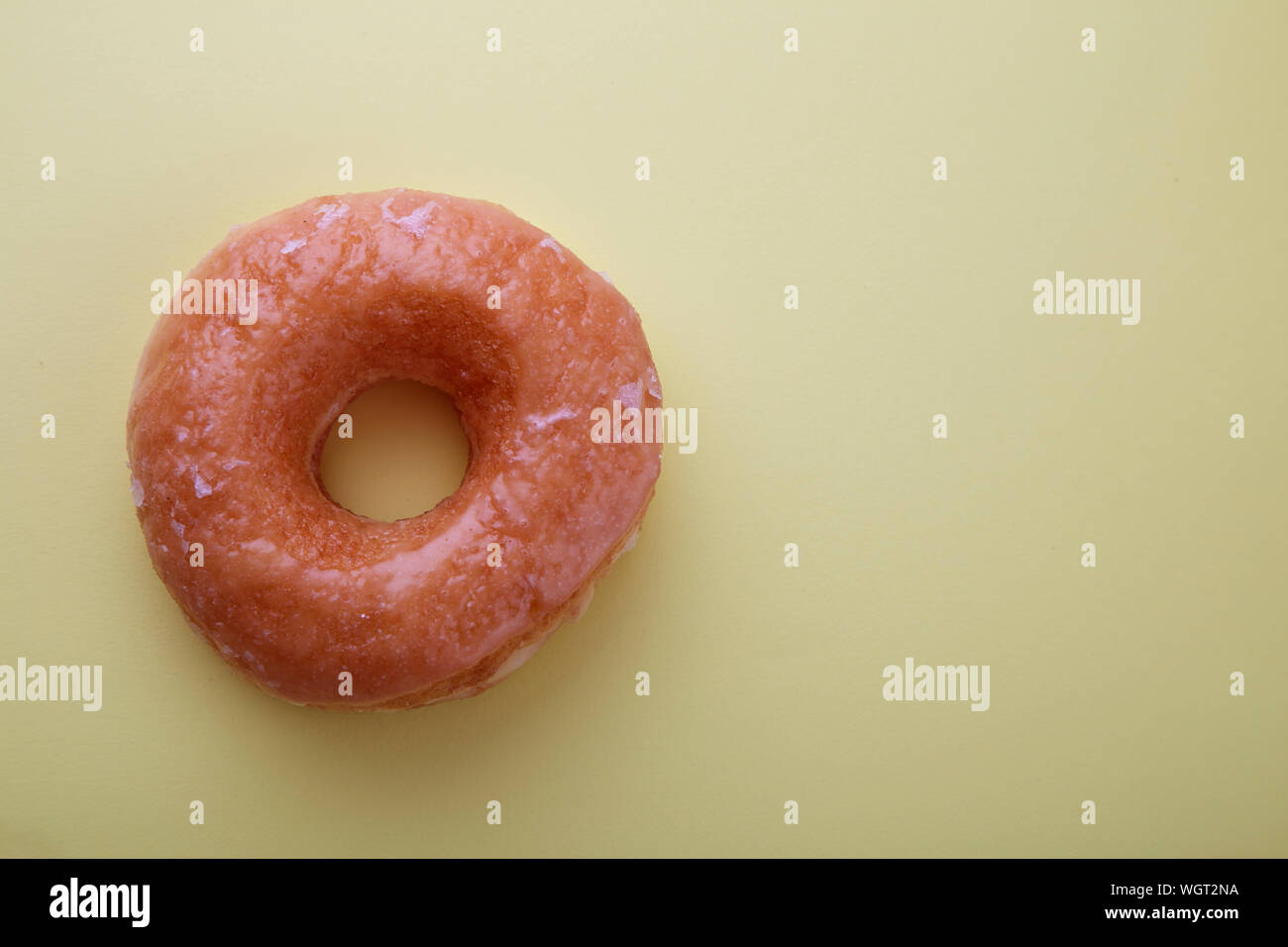 Close-up Of Donut Against Colored Background Stock Photo