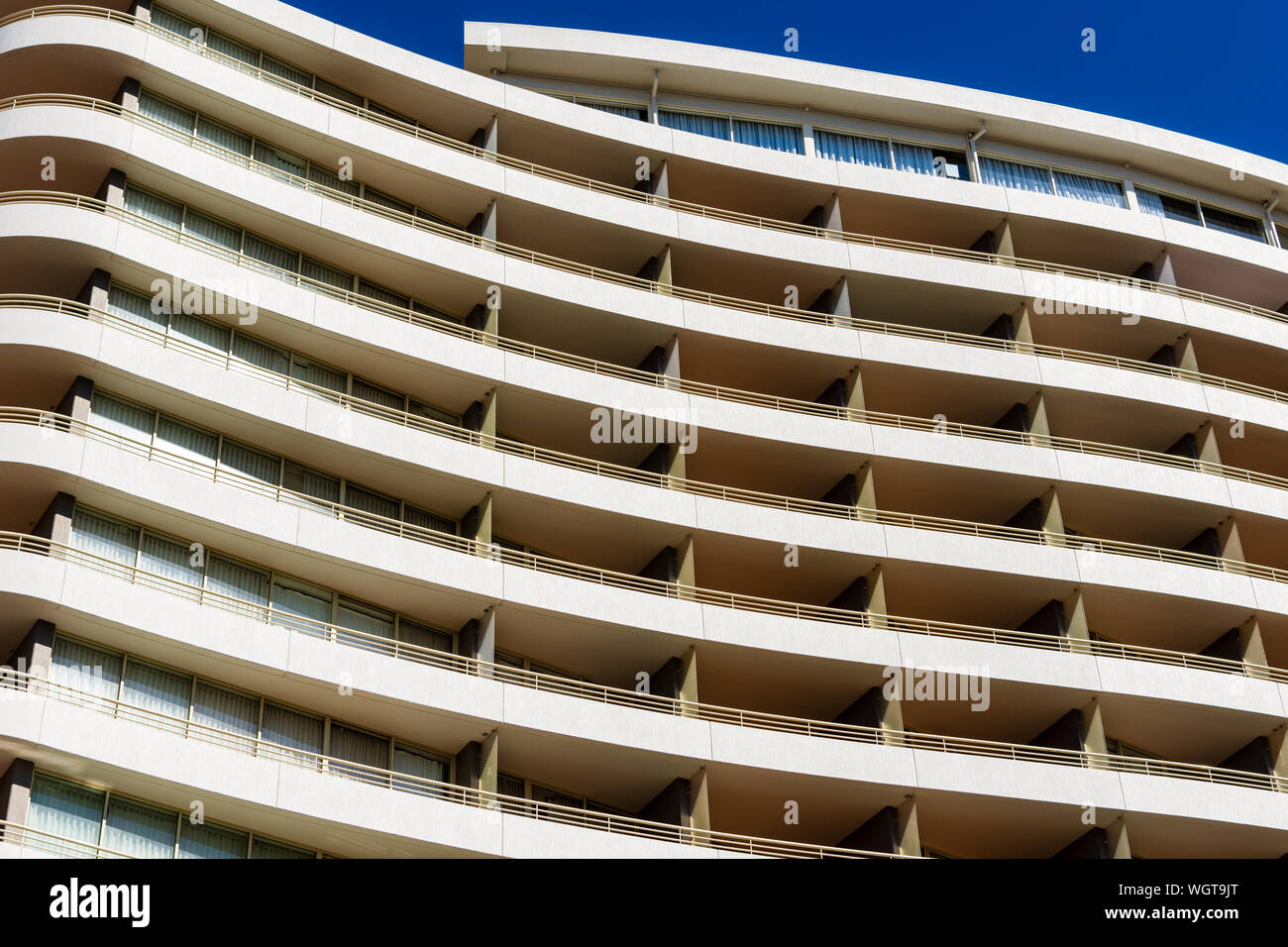 A Closeup of an Apartment Building with blue sky in the Background Stock Photo