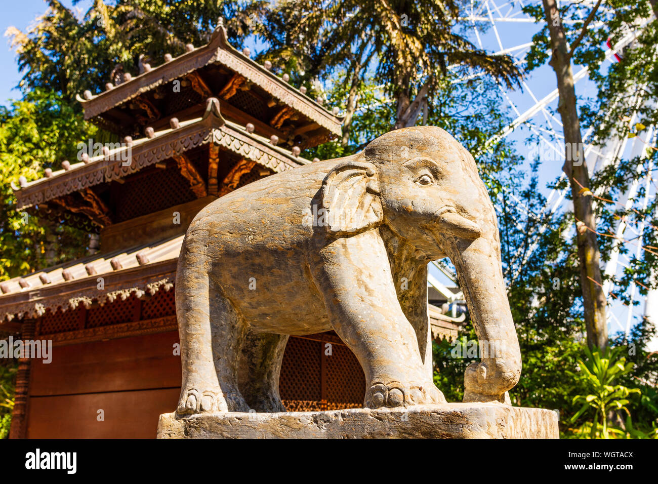 A Stone Elephant Statue out the front of a Temple. Stock Photo