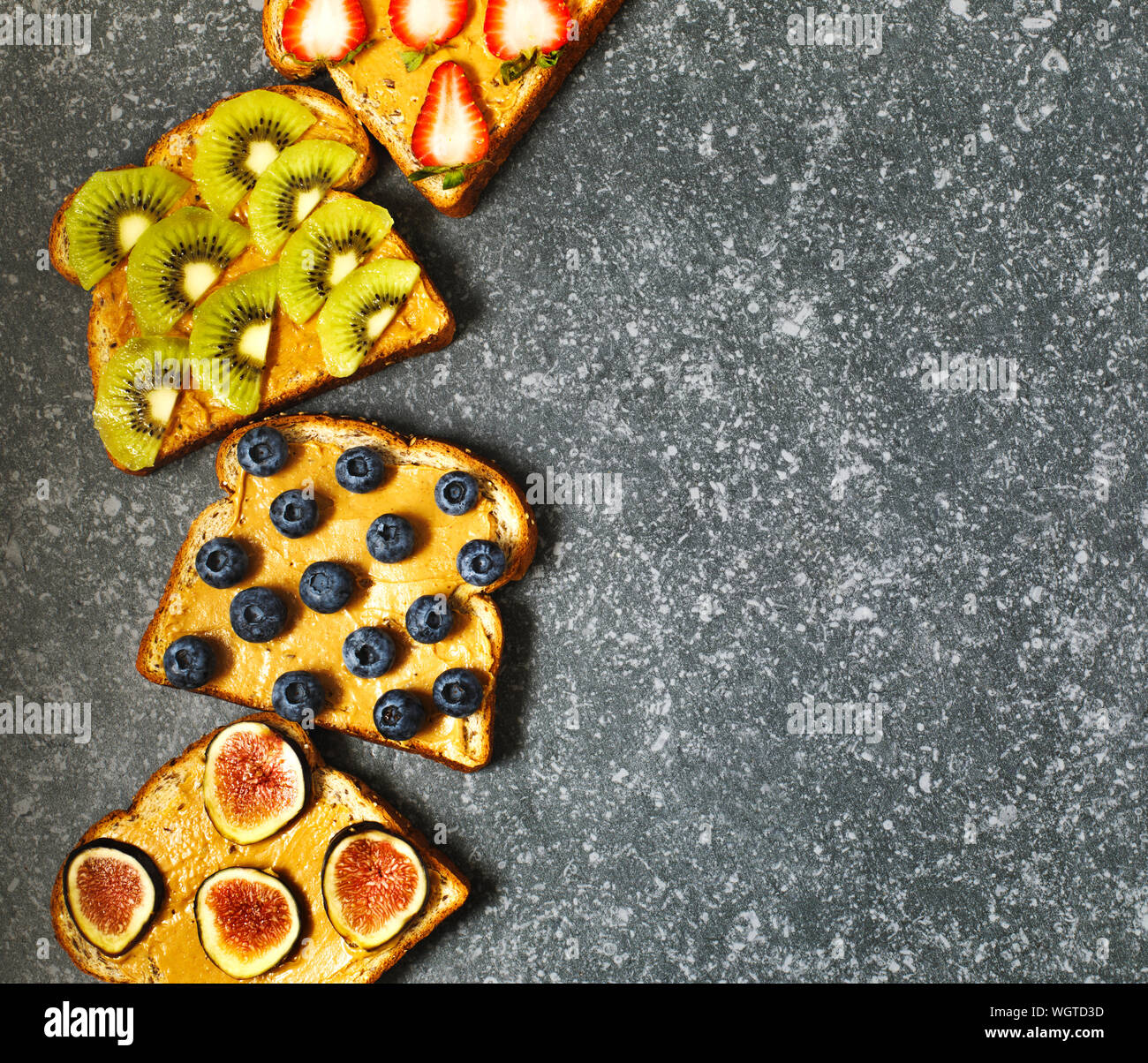 Nut butter and fruits vegan toasts Stock Photo Alamy