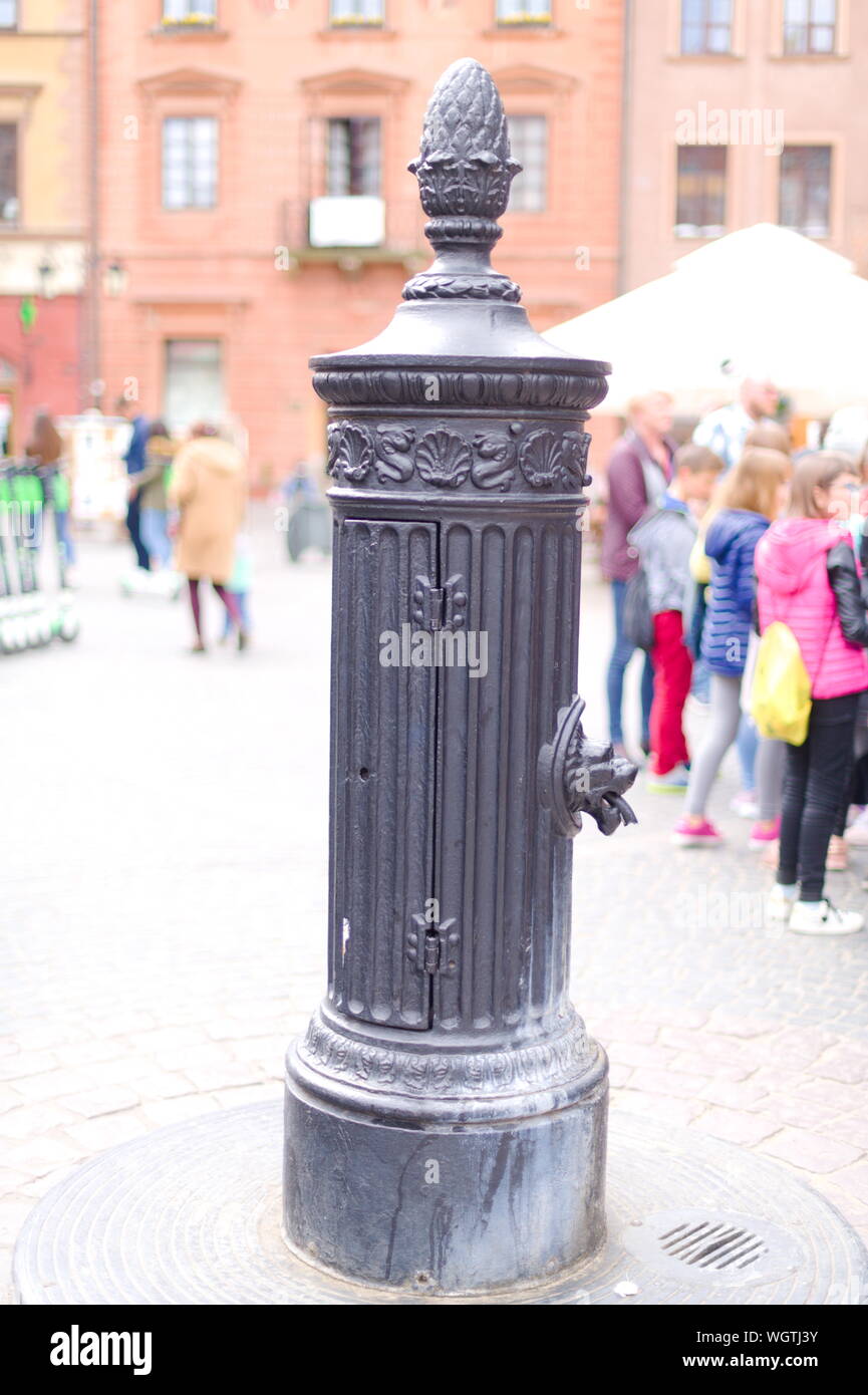 Traditional hand operated water pump in the old town market square in Warsaw, Poland Stock Photo