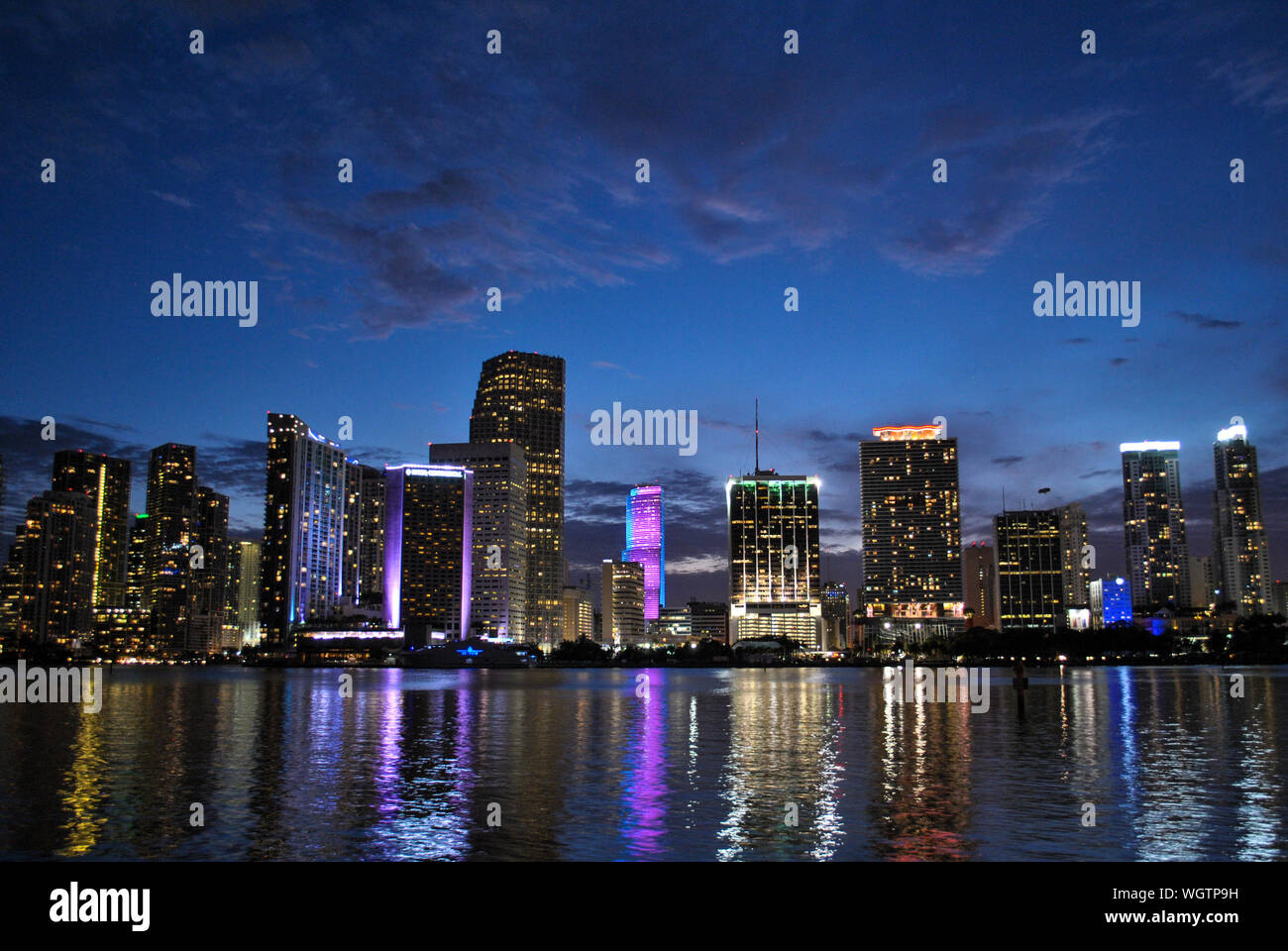 Biscayne Bay By Cityscape Against Sky At Dusk Stock Photo