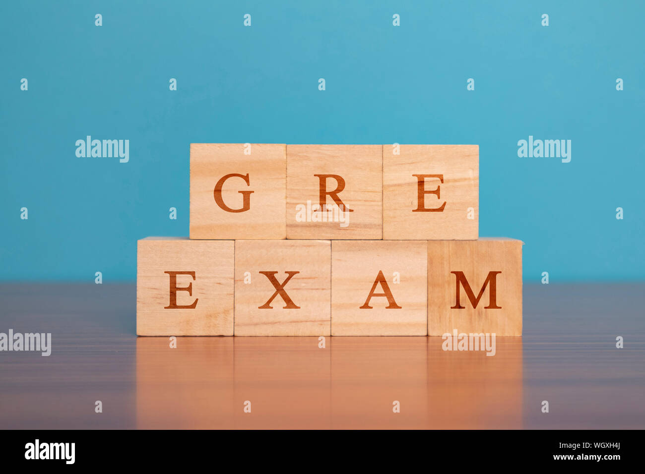 Concept of GRE Exam in wooden block letters on table. Stock Photo