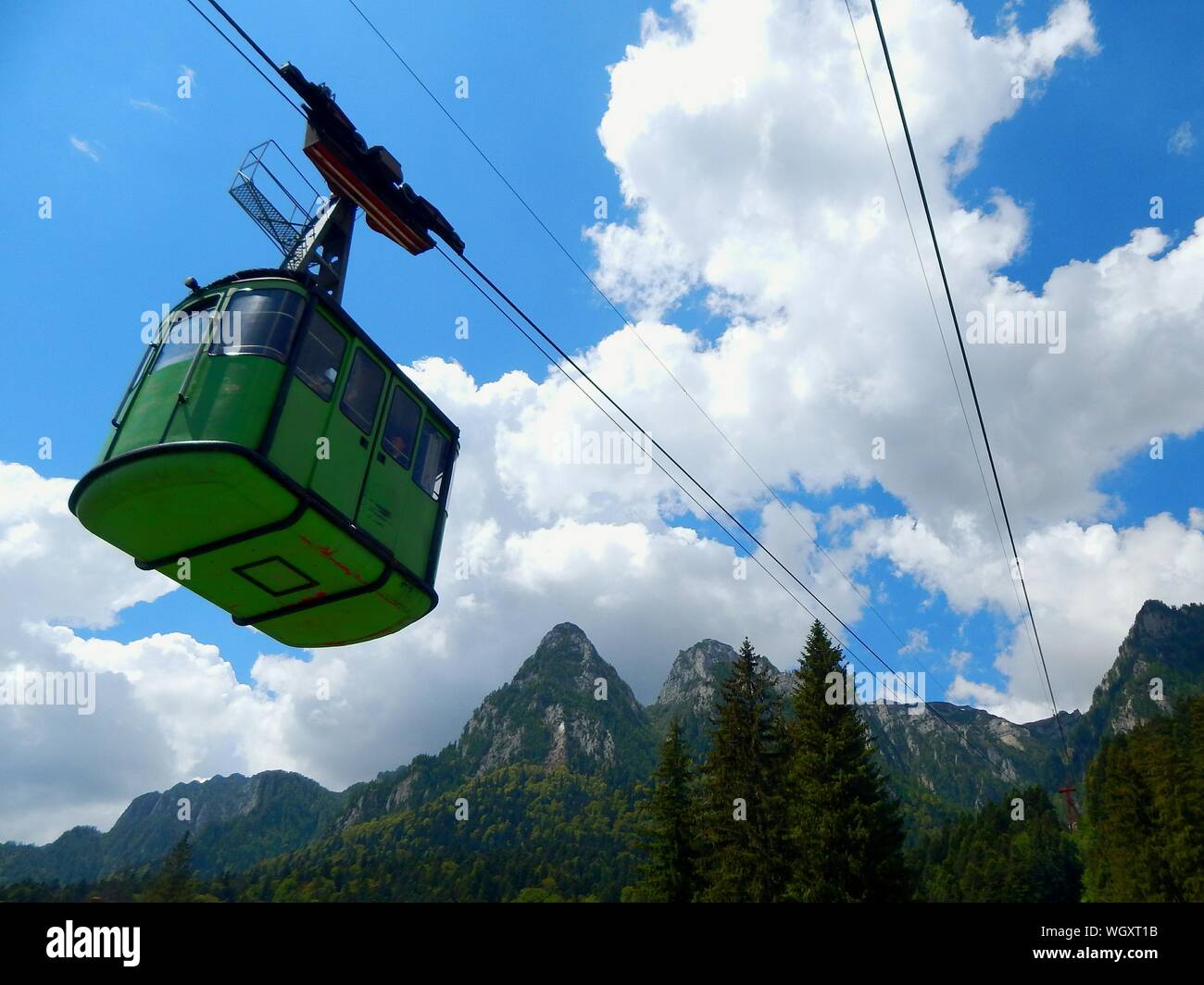 Low Angle View Of Ski Lift By Mountains Against Sky Stock Photo