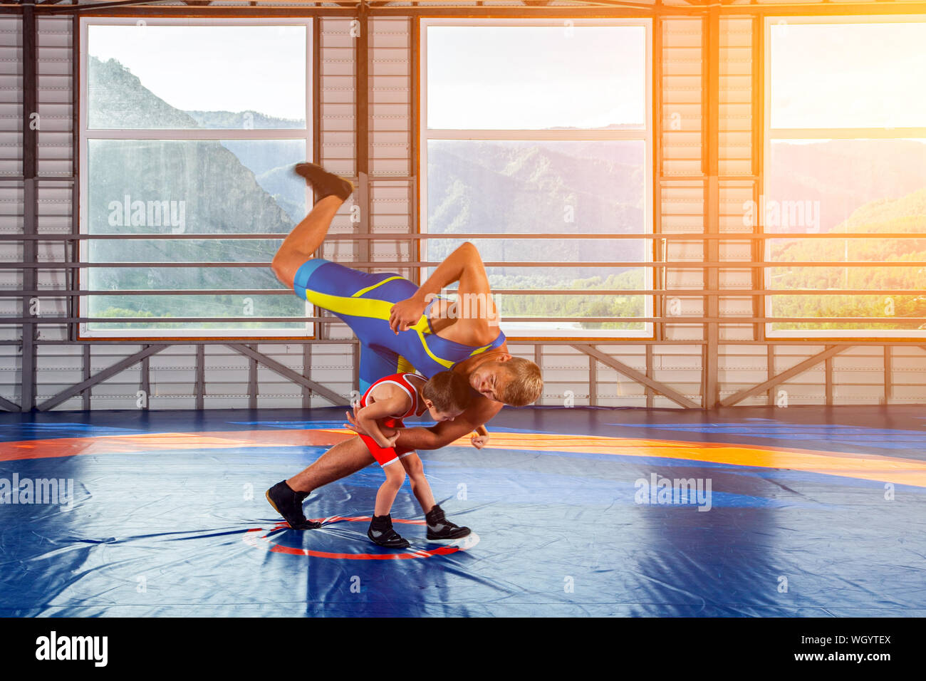 a-little-wrestler-boy-in-a-sports-tights-wrestles-with-an-adult-male