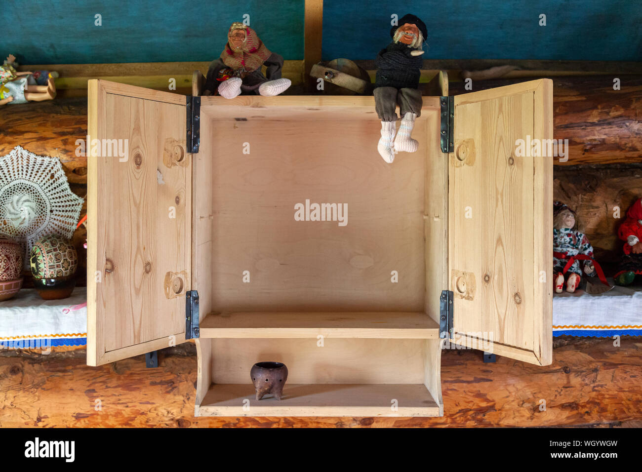 Close Up Of An Open Empty Wooden Cabinet On The Top Shelf There