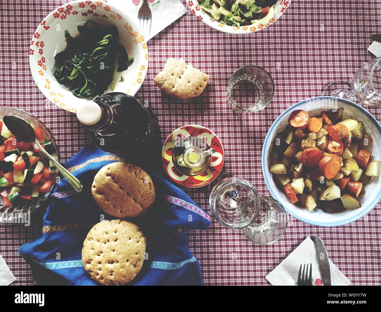 Directly Above View Of Salad And Biscuits With Tablewear On Checkered Tablecloth Stock Photo