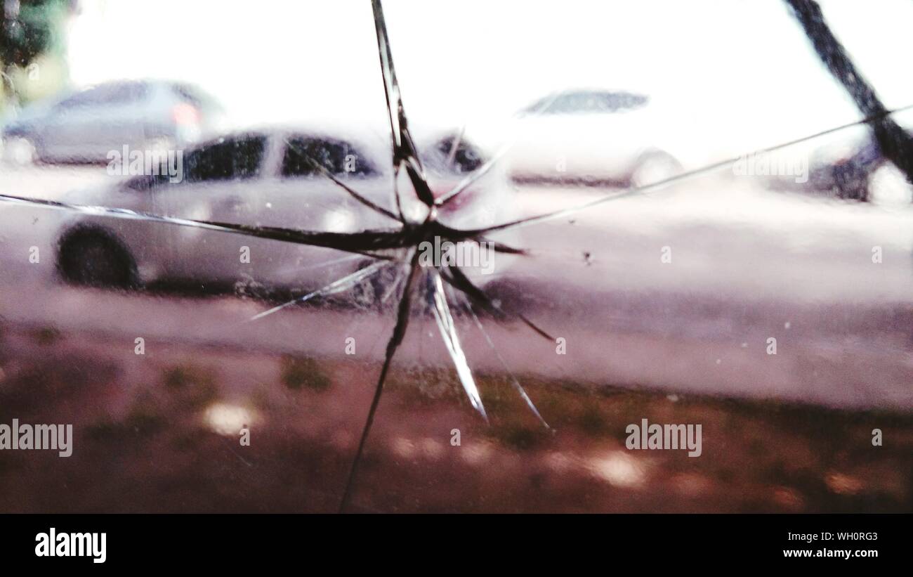 Cars On Street Seen Through Broken Glass Window Stock Photo Alamy