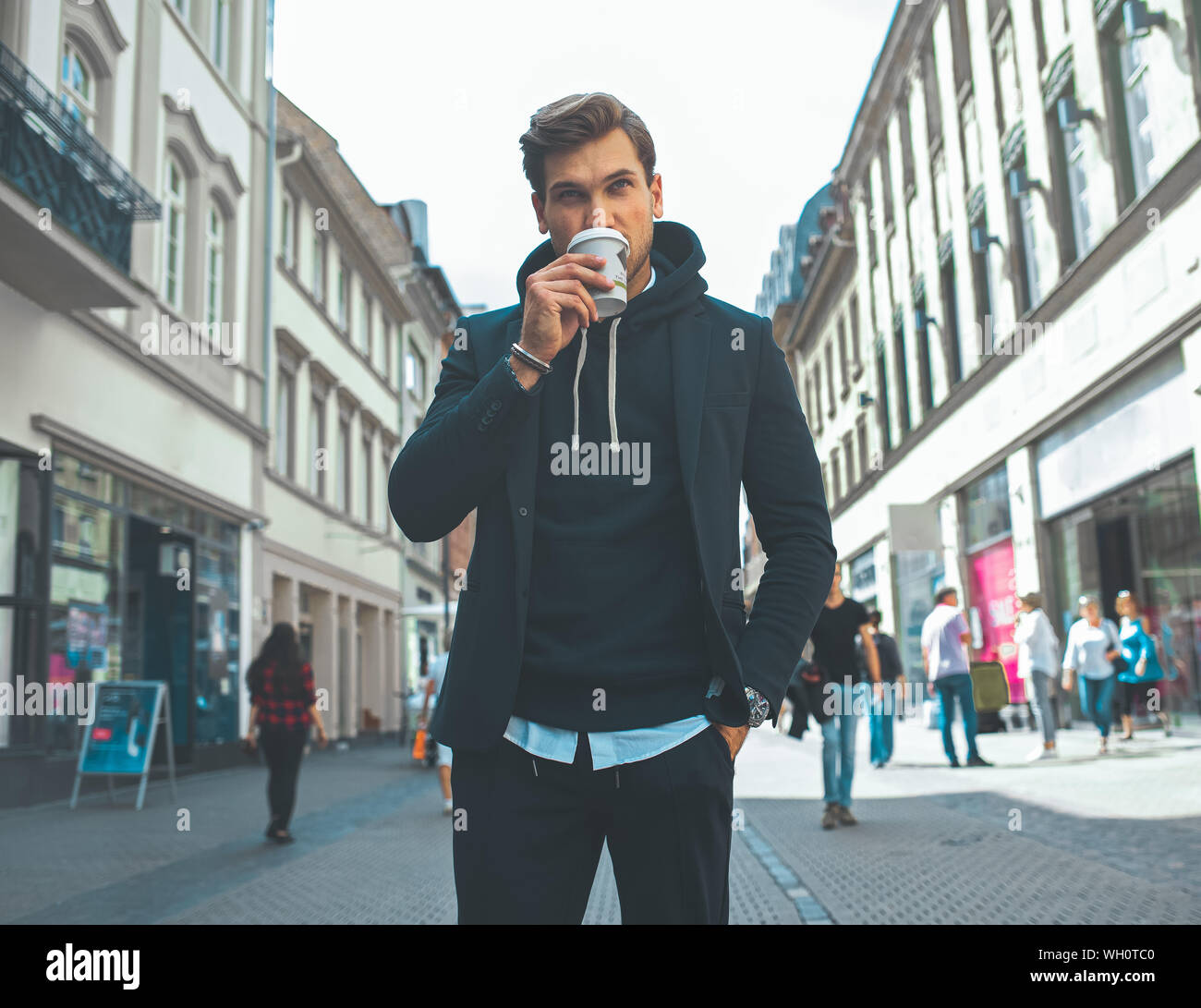 Young Adult Handsome Attractive Stylish Businessman Take a Break and Drink Coffee on the Street Stock Photo