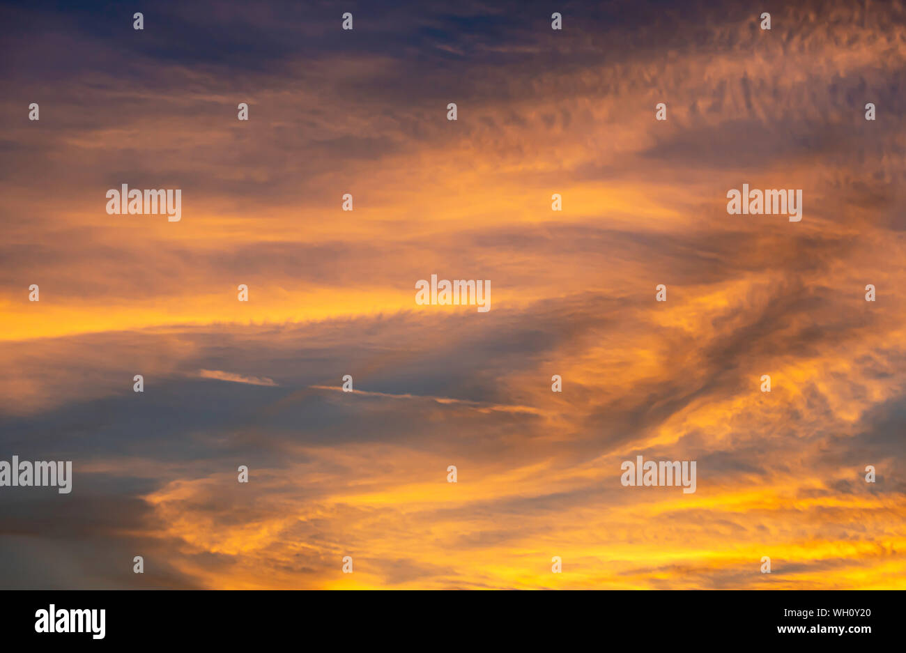 The golden light of the sun and clouds in the sky. Stock Photo