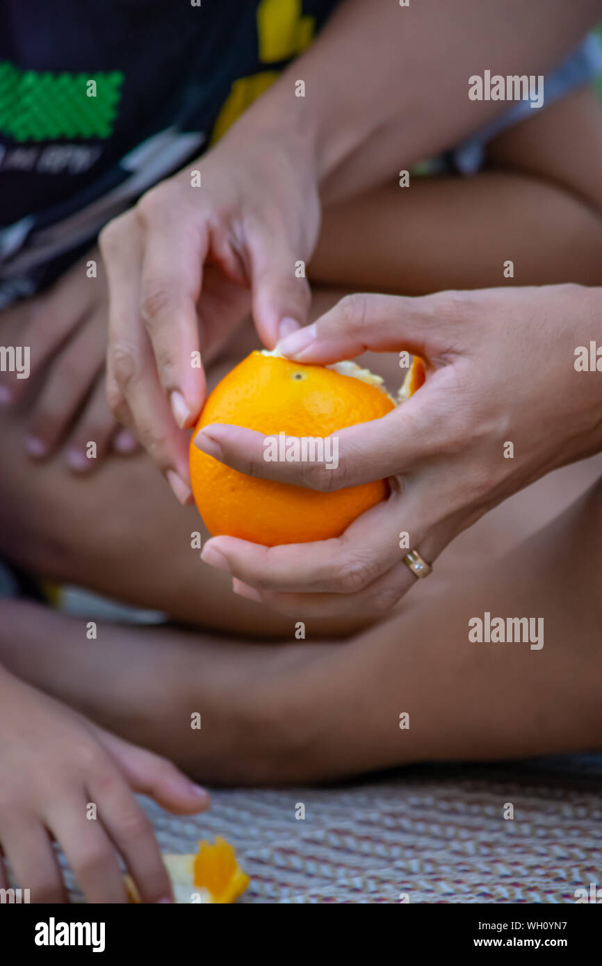 Woman peel orange fruit hi-res stock photography and images - Alamy