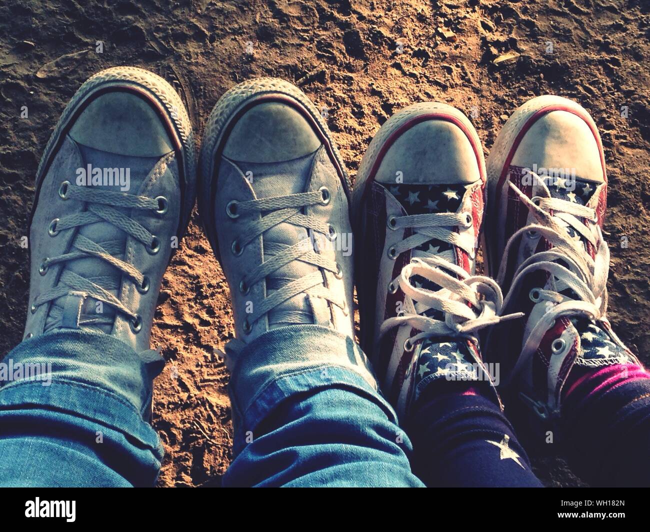 Low Section View Couple Wearing Canvas Shoes Stock Photo - Alamy