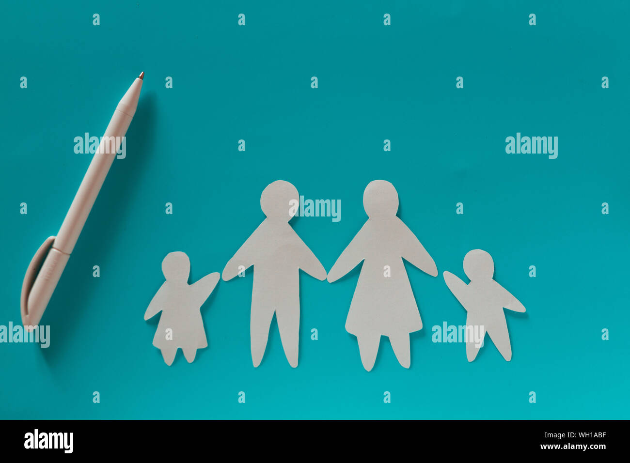 Paper family on blue background with copy space Stock Photo - Alamy