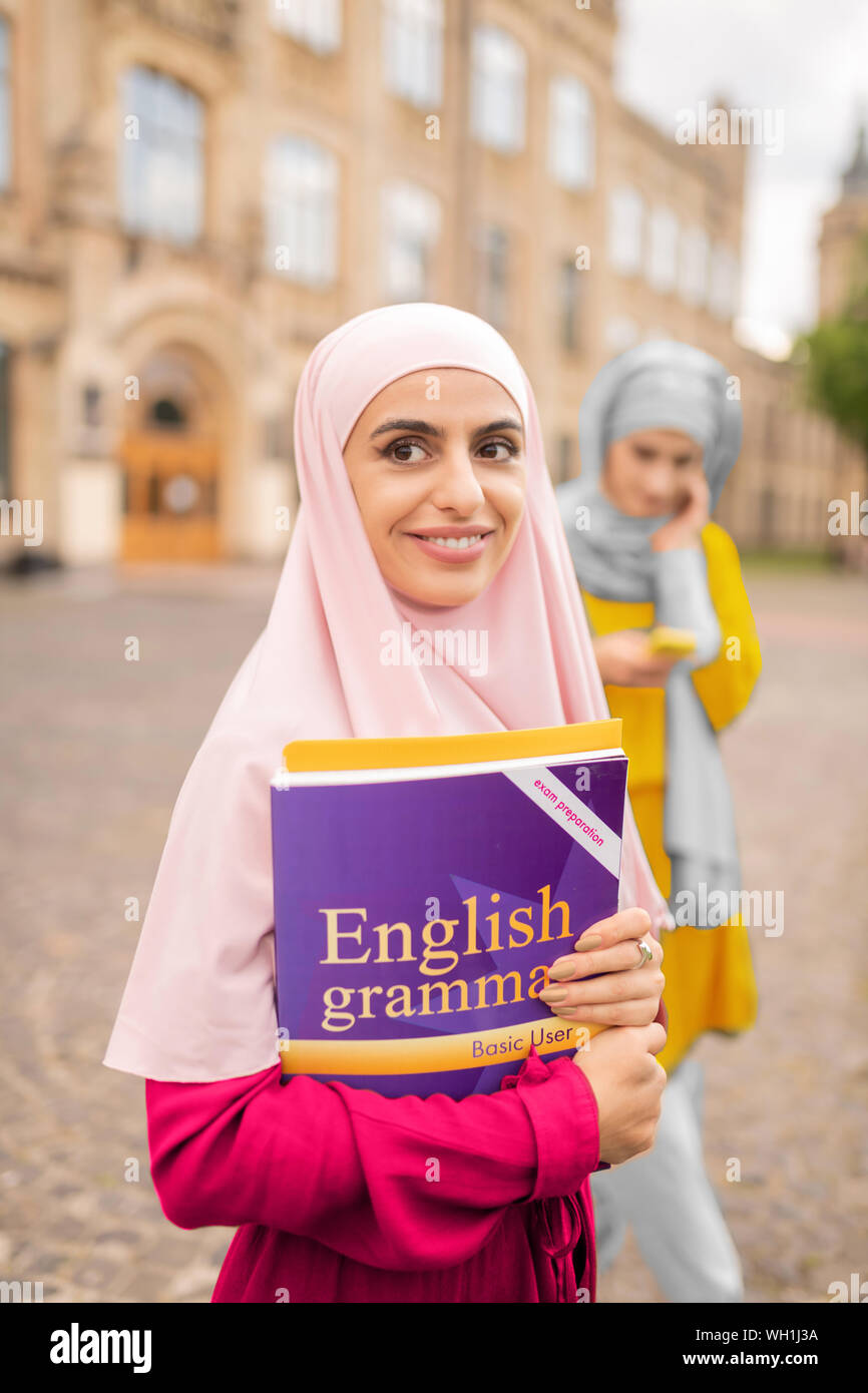 Beaming Dark eyed Muslim Woman Holding English Book Stock Photo Alamy