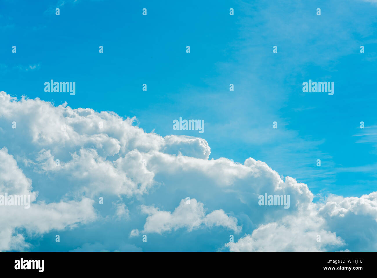 Beautiful blue sky and white cumulus clouds abstract background. Cloudscape background. Blue sky and fluffy white clouds on sunny day. Nature weather. Stock Photo