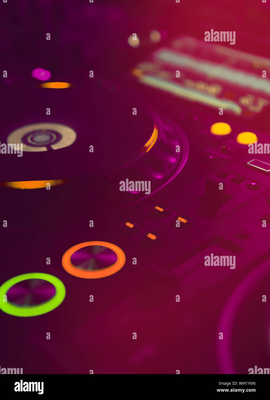 Professional dj turn table in bright red stage lights.Modern cd player