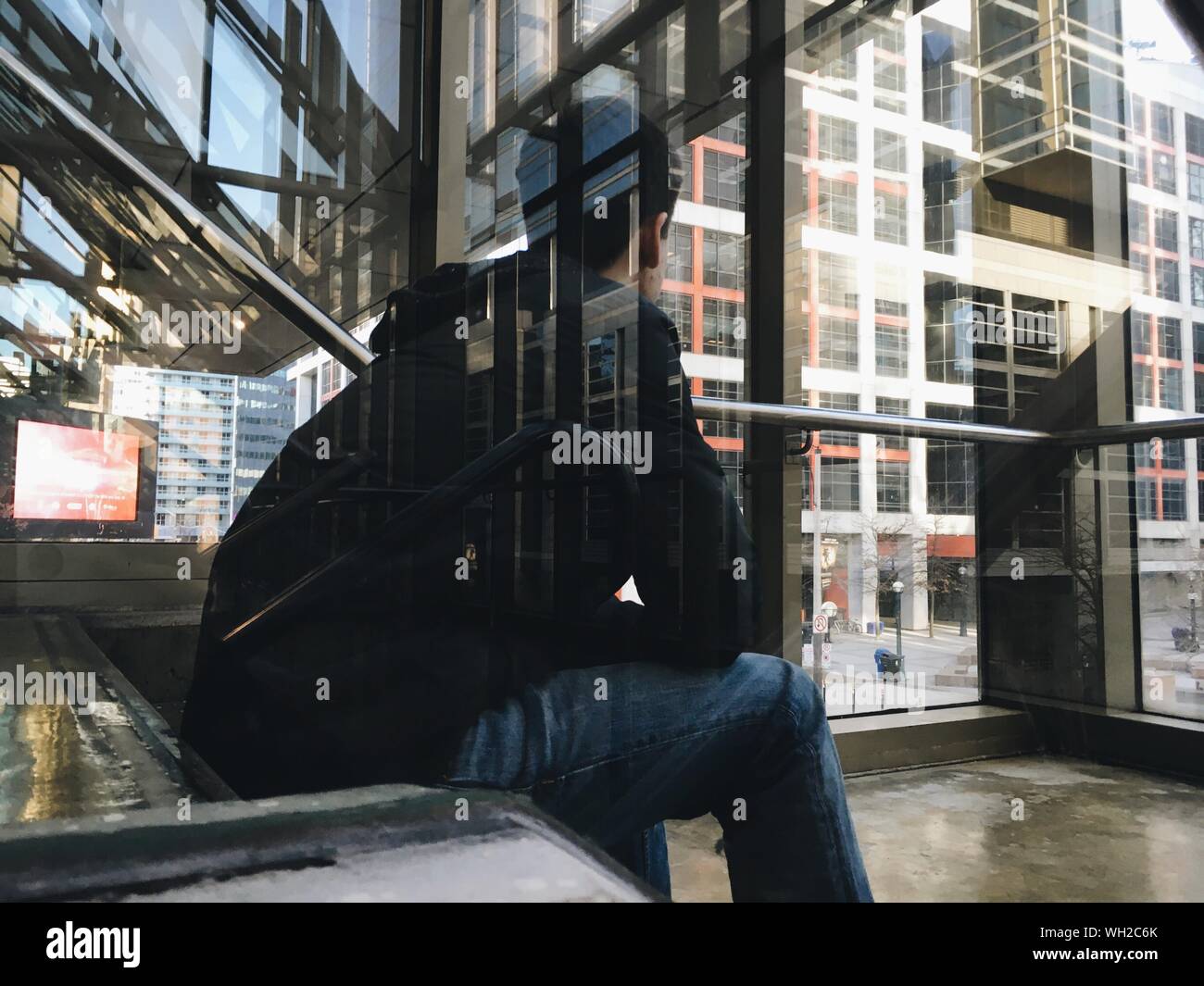 Young man sitting on stairs hi-res stock photography and images - Alamy