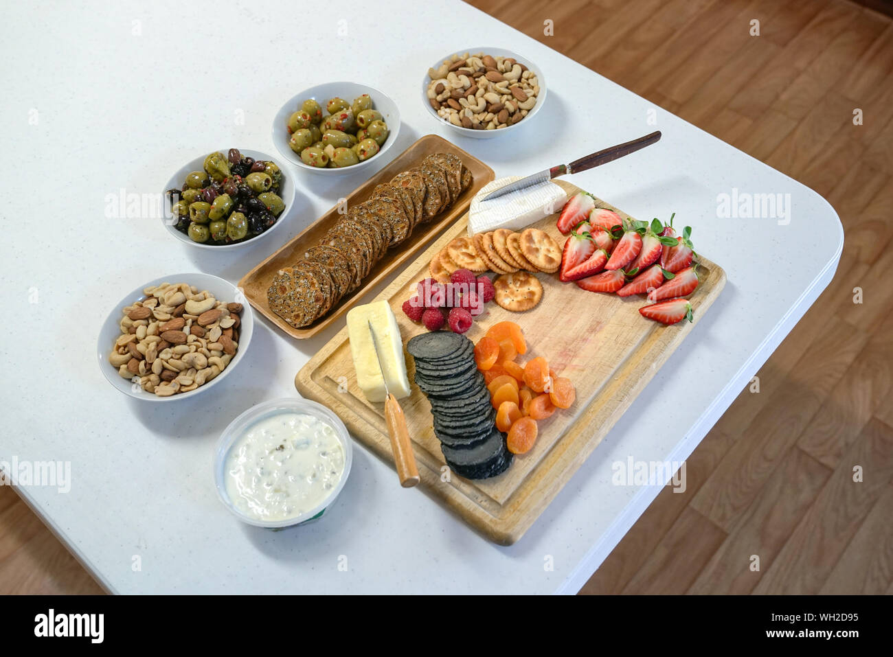 Cocktail or pre dinner snacks consists of crackers, cheese, berries