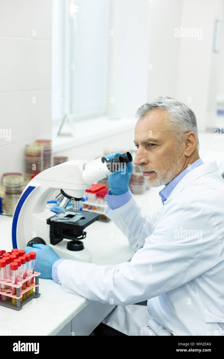 Serious grey-haired man being deep in thoughts Stock Photo