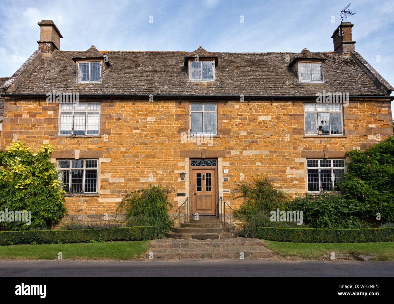 'The Manor House'. A pretty, Grade 2 listed, old (Late C17 / early C18), ironstone house with Collyweston slate roof, Lyddington, Rutland, England, UK Stock Photo