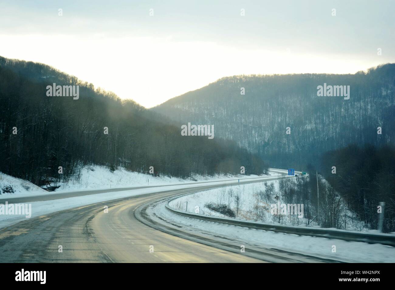 Road In Appalachian Mountains Against Sky During Winter Stock Photo