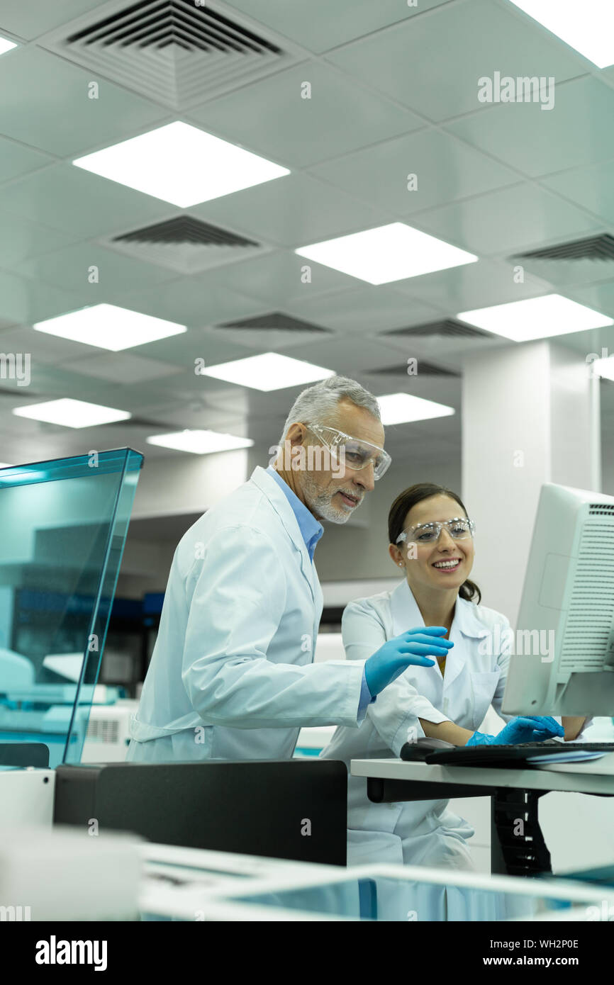 Positive delighted colleagues working in modern lab Stock Photo - Alamy