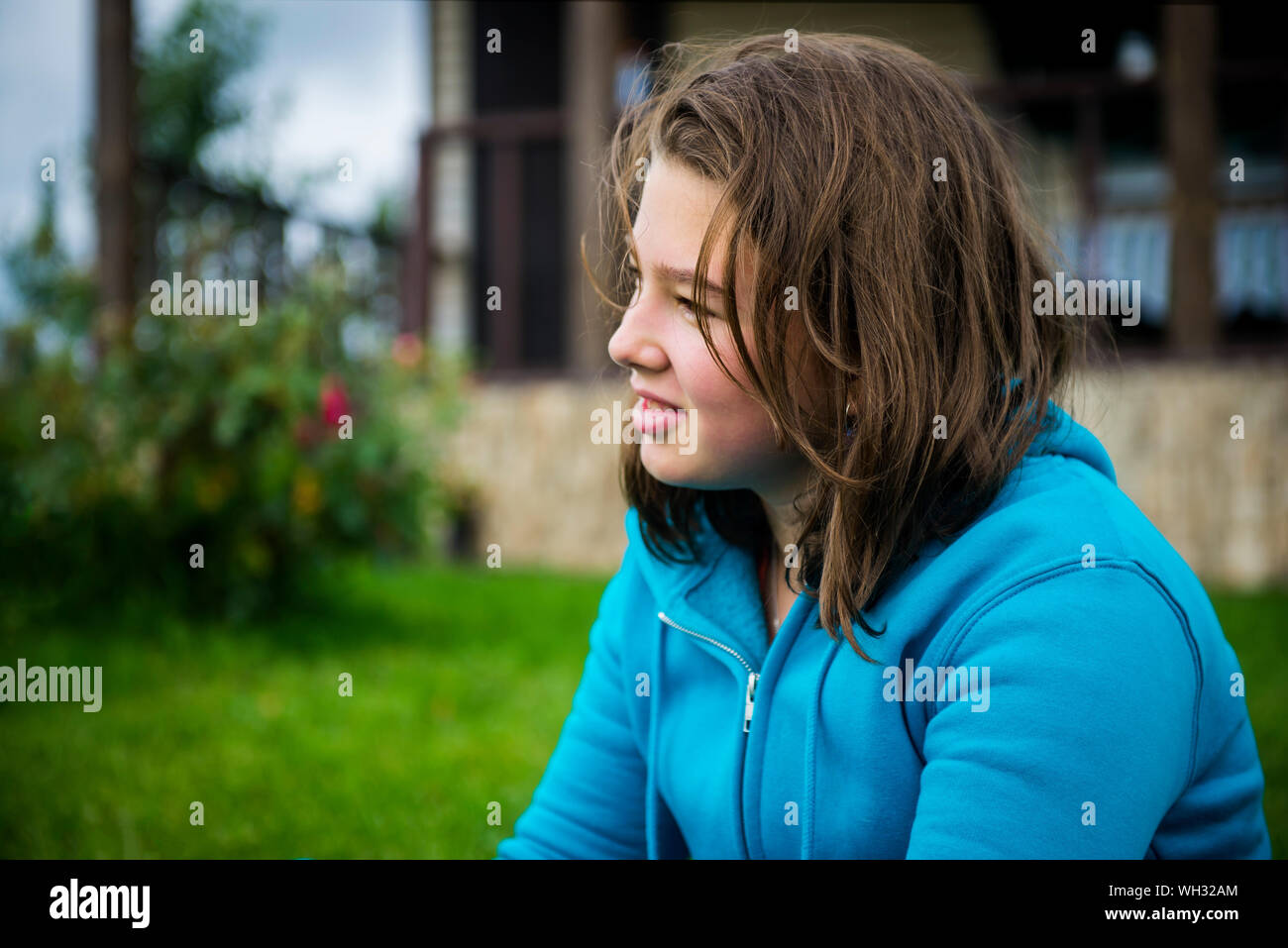 Close-up Of Teenage Girl Sitting On Field Stock Photo - Alamy