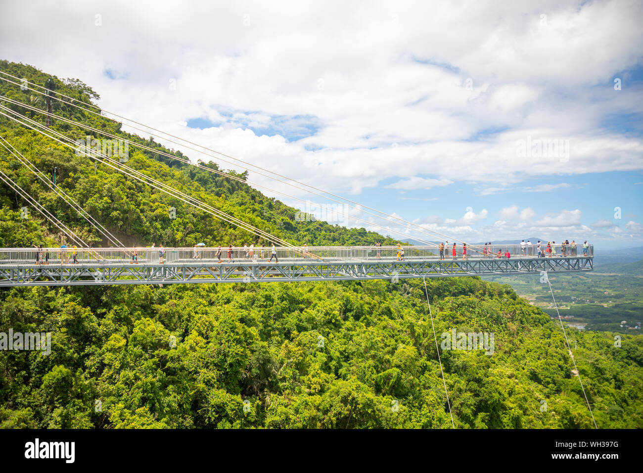 Yanoda, Hainan, China 3.07.2019 People on panorama glass bridge in