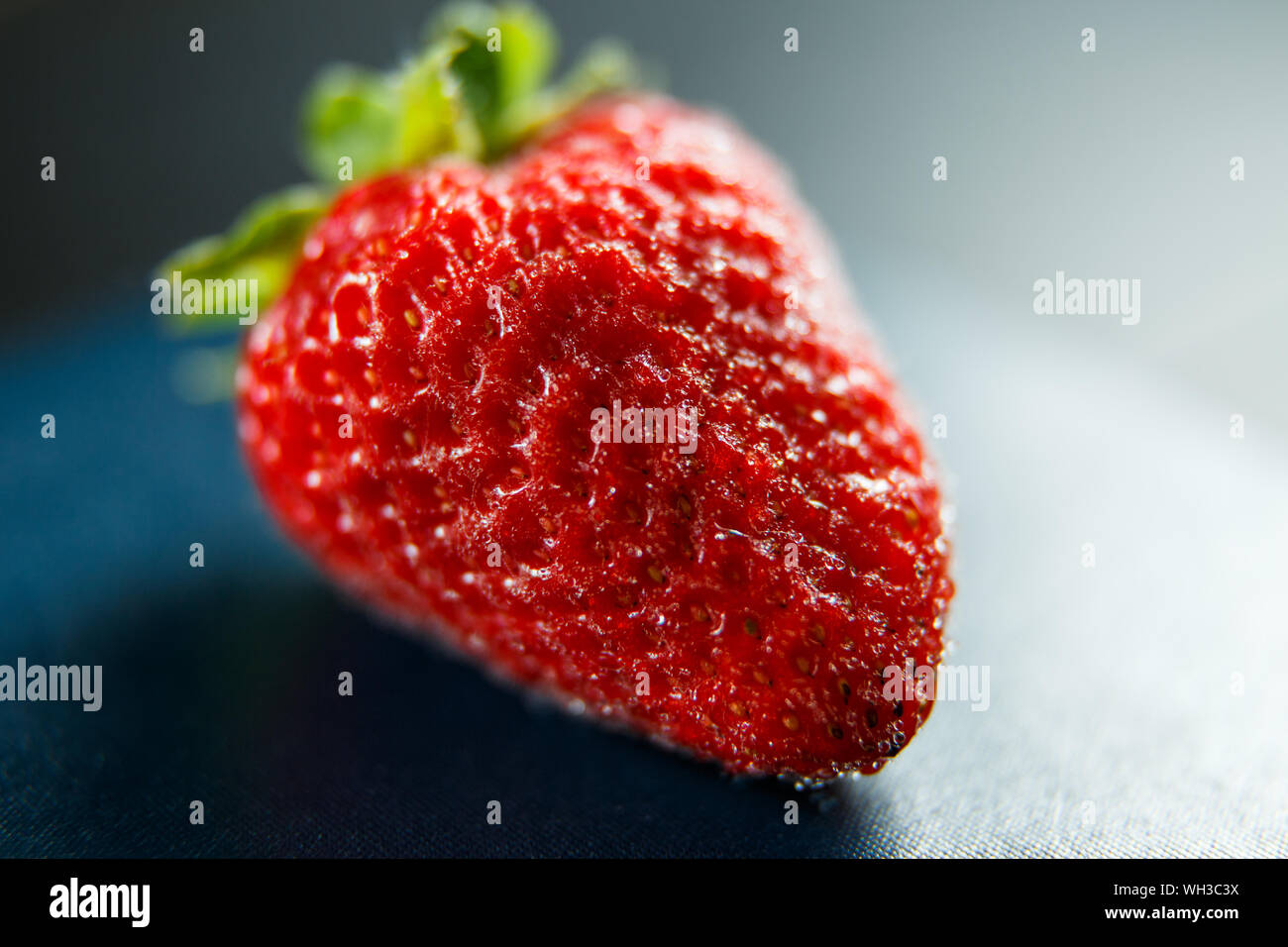 Fresh red strawberry isolated on a black background Stock Photo - Alamy
