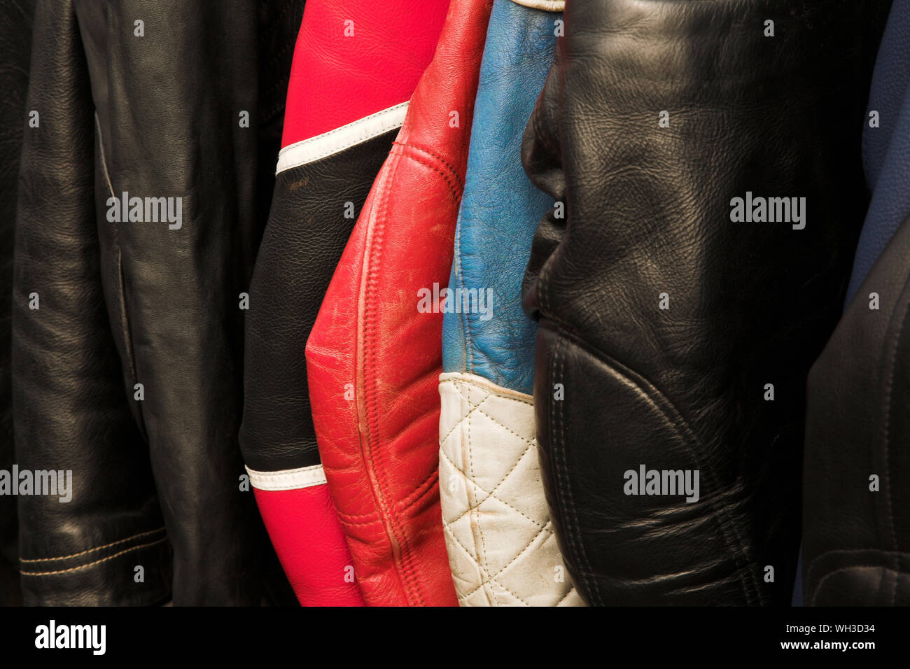 Close-up Of Colorful Leather Jackets Hanging In Store Stock Photo