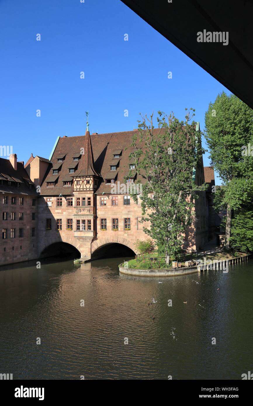 Nuremberg landmark city in Germany (region of Middle Franconia). Holy Spirit Hospital (Heilig-Geist-Spital) on river Pegnitz. Stock Photo
