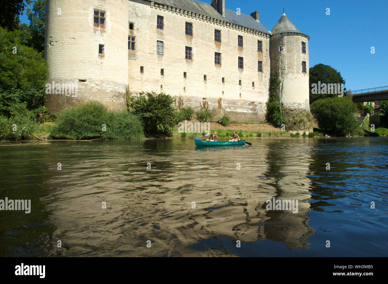 The Chateau de La Guerche with two children in a kayak on river La Creuse in Indre and Loire Valley, France Stock Photo