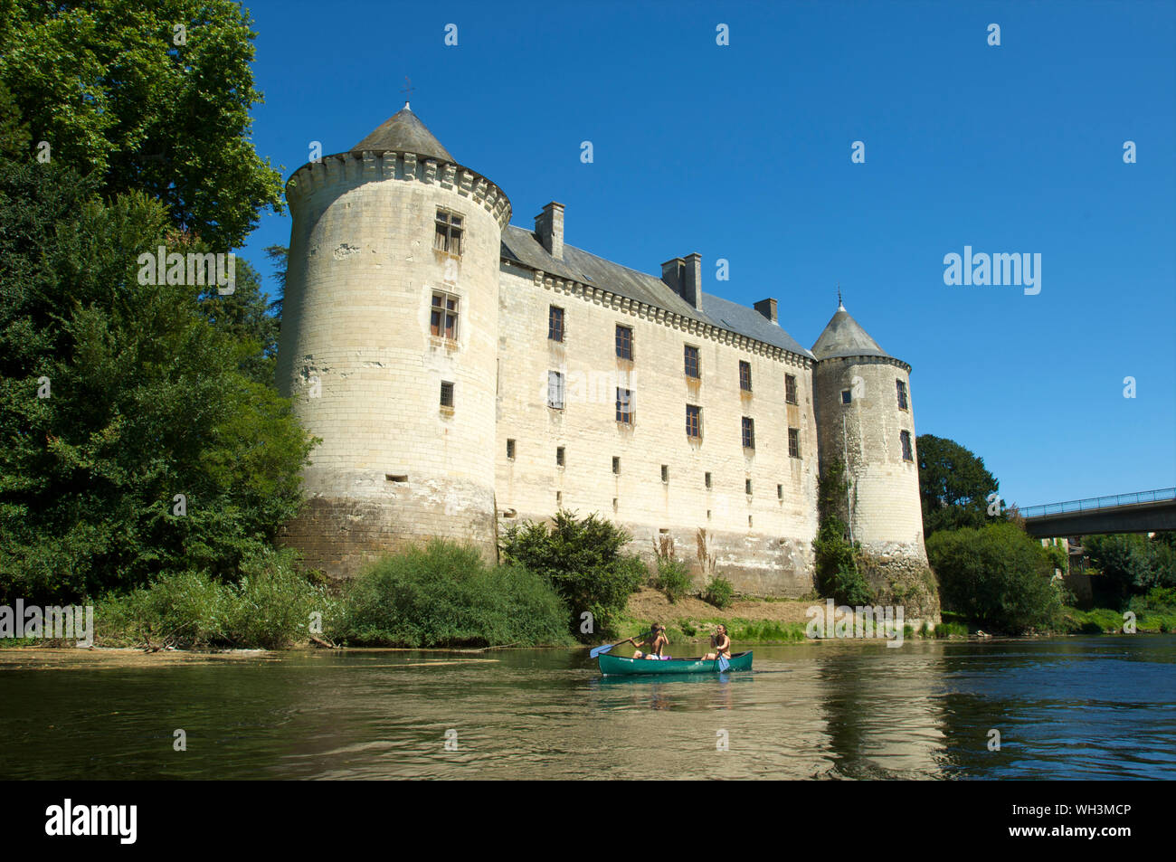 The Chateau de La Guerche with two children in a kayak on river La Creuse in Indre and Loire Valley, France Stock Photo